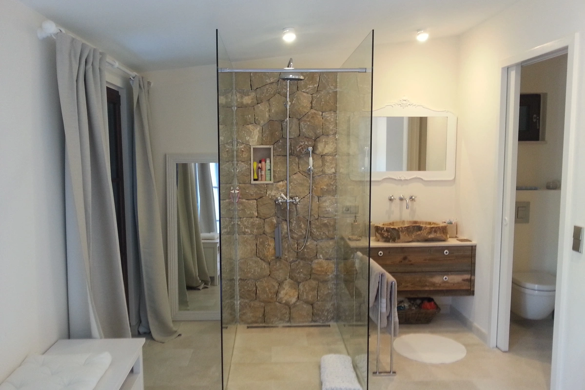 Architect Mallorca finca rustica  spacious bathroom with glass shower and quarry stone, Es Raiguer 2